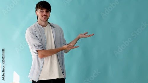 teenage student in casual outfit pointing isolated on background