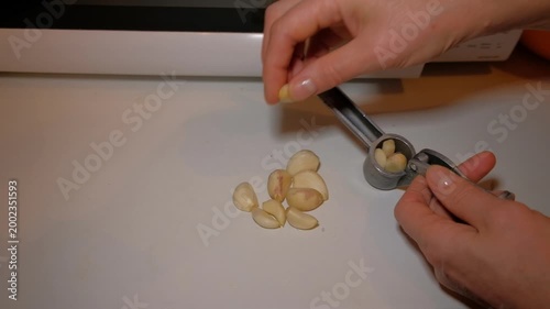 A man peels garlic for seasoning with his hands on a table hand holding a key
