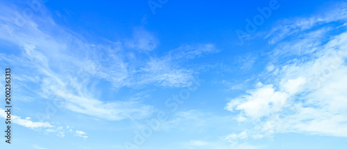 Beautiful panoramic view of bright blue sky with wispy white cirrus clouds background on a sunny day
