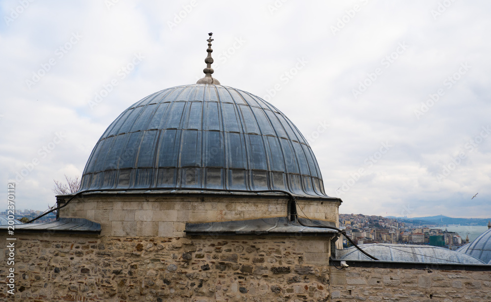 Fototapeta premium The Suleymaniye Mosque is one of Istanbul most famous landmarks, and its location on the Third Hill offers expansive views of the city around the Golden Horn against the backdrop of a gloomy sky on a