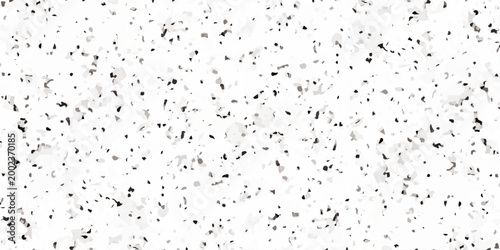 White terrazzo texture background with black and gray mineral flecks, seamless granite pattern. Minimalist white terrazzo background featuring a dense distribution of black and gray stone fragments.
