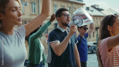 Protesters are passionately rallying for change while using a megaphone during their demonstration