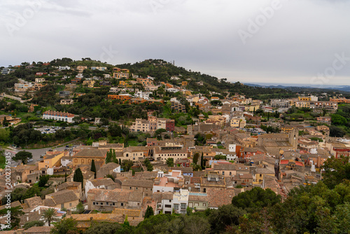 Aerial view of Mediterranean hillside village with terracotta rooftops