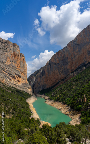 Dramatic canyon gorge with turquoise reservoir lake and steep cliffs