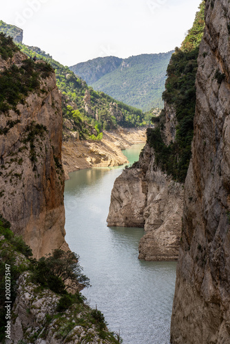 Dramatic limestone gorge with turquoise river flowing between cliffs