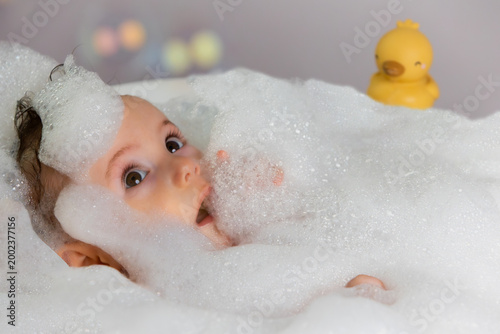 Canvas-taulu Happy baby enjoying bubble bath with toy duck