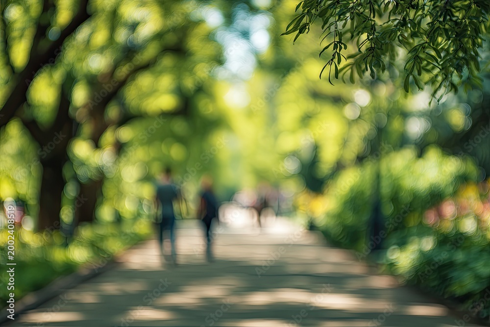 Obraz premium Emerald pathways, dappled light, serene movement, distant figures, verdant tranquility.