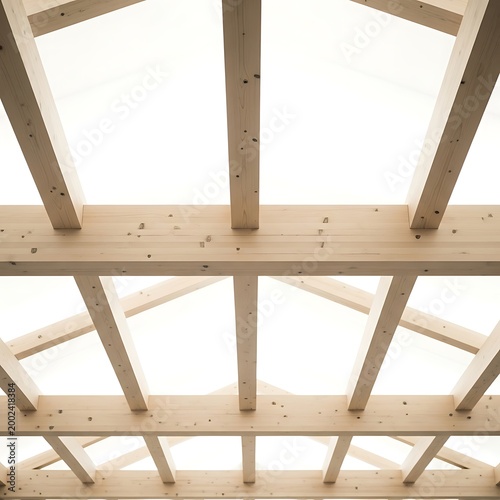 Modern wooden roof truss and beam construction under a bright white sky