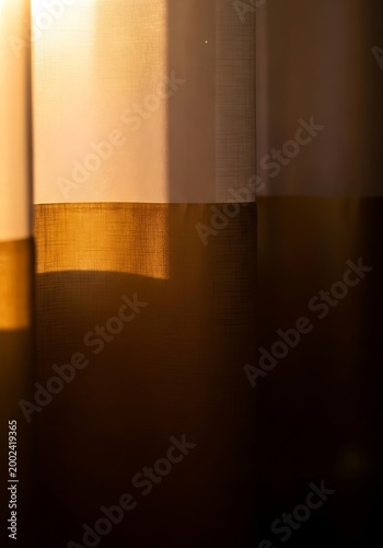 Warm sunlight filtering through sheer curtains creating soft golden light and shadows