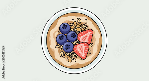 Overhead view of healthy oatmeal bowl with fresh blueberries and strawberries, granola, and nuts.