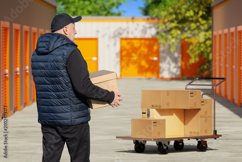 Man carries moving boxes at...