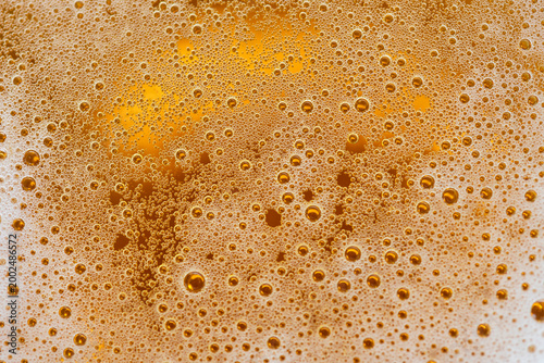 Картината върху платно Golden beer bubbles macro texture with foam abstract background close up