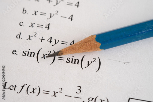 Pencil on mathematic formula exercise test paper in education school.