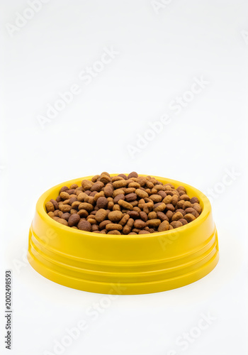 Yellow bowl filled with dry kibble pet food