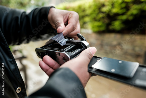 Person loading 35mm film into vintage analog camera