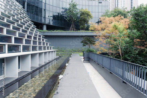 Modern Urban Landscape Architecture with Glass Building Reflection Water Feature and Green Trees