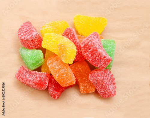 Jelly sugar candies isolated on wooden background 