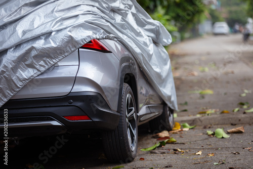 A car covered with a protective cover highlights the importance of shielding vehicles from dust, dirt, and stains, while choosing the right material ensures durability, cleanliness, and longterm care.