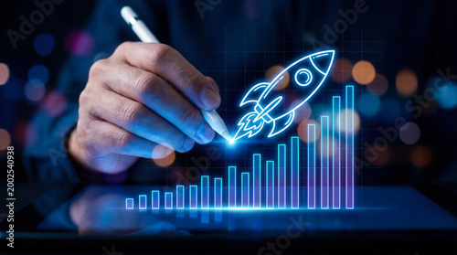 Businessman Drawing a Rocket Launching Over a Digital Bar Chart for Business Growth and Success
