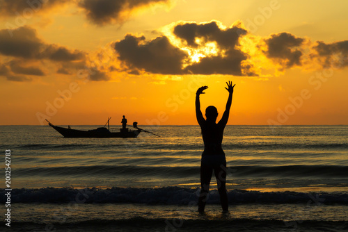 Woman enjoy with sunrise and silhouette