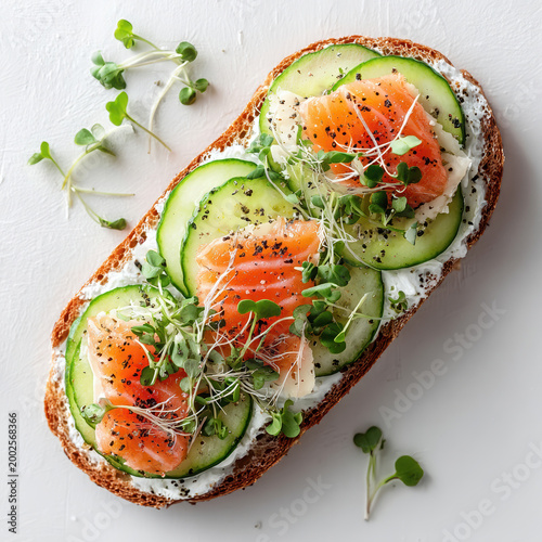 Open faced salmon toast with cream cheese cucumber slices and fresh green microgreens topping