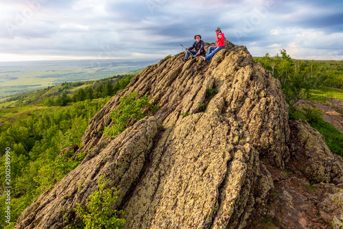 happy mature married couple traveling through the Ural mountains on a summer day