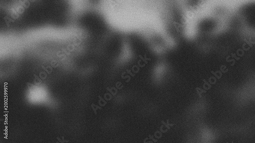 Monochrome abstract background featuring a creative grainy noise texture with soft out-of-focus light spots. A minimalist aesthetic design perfect for cinematic posters, vintage style backdrops.