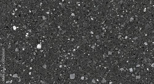 Dark speckled granite texture abstract background with small white and gray stone particles perfect for construction or design projects