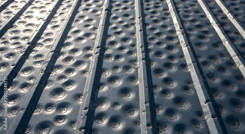 Severe hail damage on corrugated metal roof after heavy storm impact close.