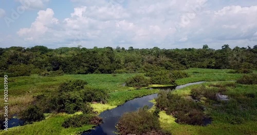 Drone takeoff from wooden boat rising above Amazon rainforest revealing tropical jungle landscape in South America