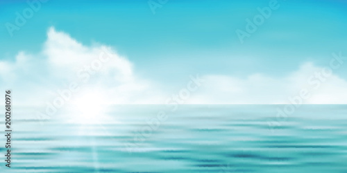 Bright blue sky with soft white clouds over calm ocean water