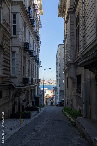 Istanbul Cihangir Narrow Cobblestone Street with Bosphorus View, Historic Apartment Buildings, Turkey