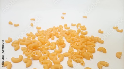 Elbow Macaroni Pasta Dropping on White Background, Uncooked Elbow Macaroni Pasta Ingredient