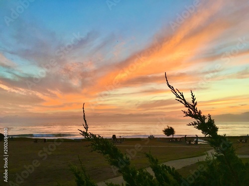 Εκτύπωση καμβά Vibrant orange clouds and sunset afterglow along a coastal path in San Simeon, California