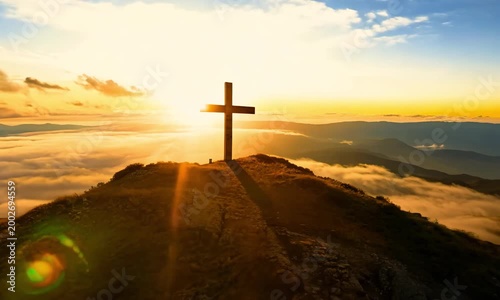 a wooden Christian cross placed prominently on a mountaintop.