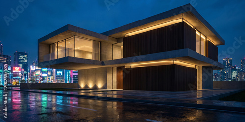 Modern house with city lights at night.