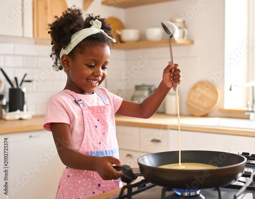 Young girl cooking pancakes in a kitchen, smiling and pouring batter
