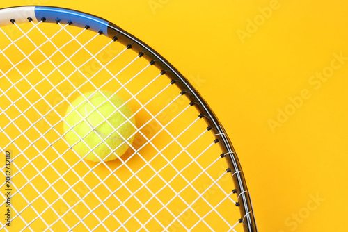 Obraz na plátně Large tennis court, balls and tennis racket on a yellow background