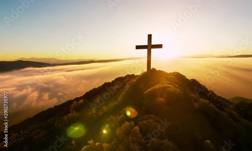 a wooden Christian cross placed prominently on a mountaintop.