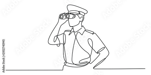 Man in uniform looking through binoculars