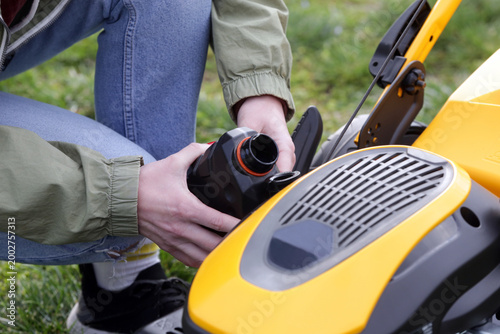 Pouring Oil Into Lawn Mower and Checking Oil Level – Small Engine Maintenance Close Up - Countryside Living and Outdoor Chores Lifestyle