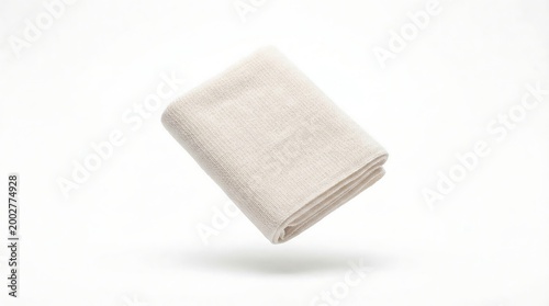 Floating White Towel Over Clean Studio Background.