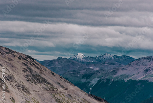 High Andean peaks covered in snow under a heavy gray overcast sky in southern Argentina.