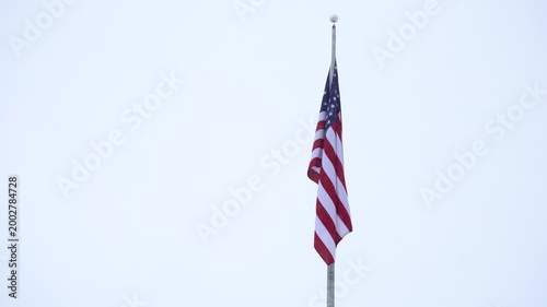 American Flag Waving Against Cloudy Sky