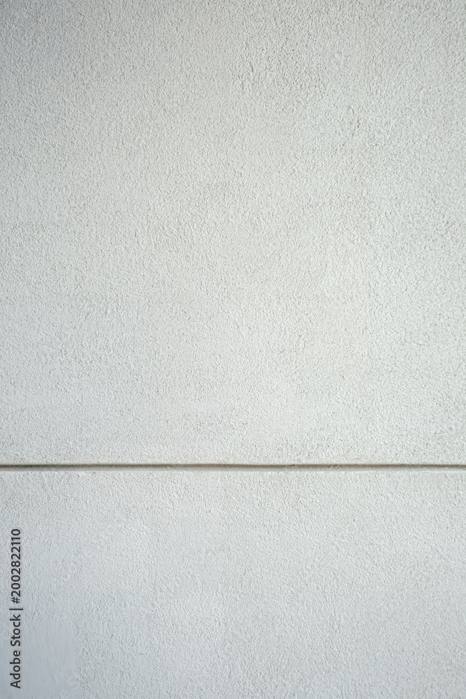Fototapeta premium Light grey concrete wall with smooth seamless texture, perfect for modern architectural background.