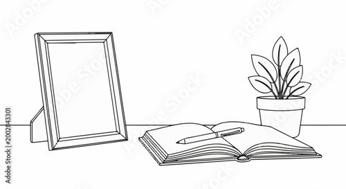 Minimalist still life an open book with pen, picture frame, and potted plant
