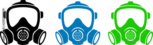 Three colorful gas masks in black, blue, and green, isolated on a white background, symbolizing protection and safety equipment.