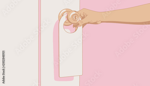 Hand holding a blank door hanger on a pink door, concept of privacy and do not disturb