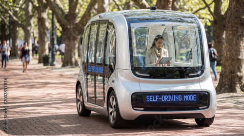 Business woman working inside autonomous self driving shuttle vehicle
