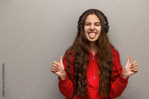 Obraz na plátne Playful Teenage Girl Wearing Headphones